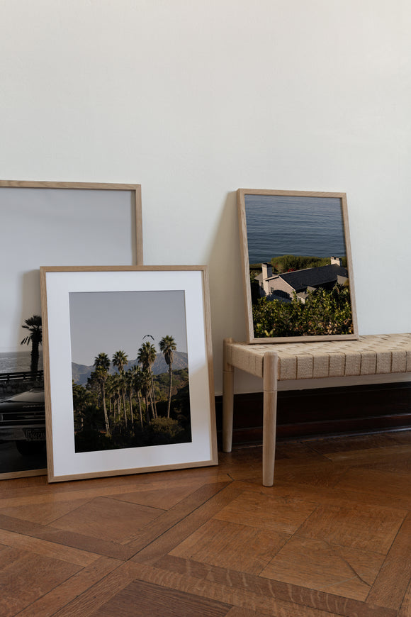 A collection of framed fine art prints featuring coastal scenes of Santa Barbara, California.