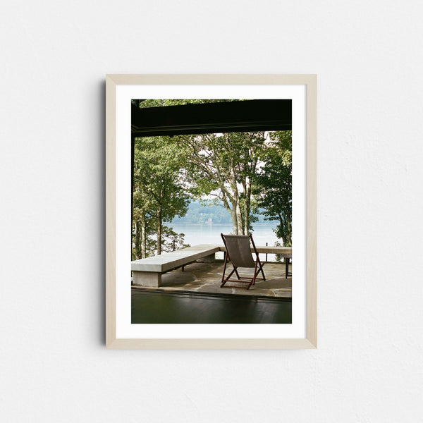 A framed fine art photography print featuring a view looking out of a house towards the Hudson River in New York.
