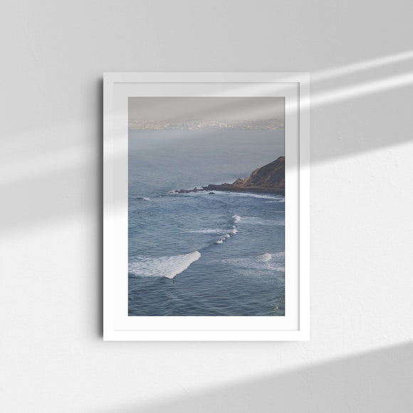 A framed fine art photography print featuring a surfer, the cliffs and blue ocean in Palos Verdes, California.