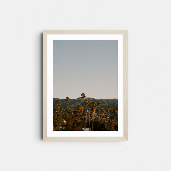 A framed fine art photography print featuring palm trees and mountains at sunrise in Santa Barbara, California.