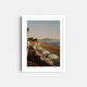 A framed fine art photography print featuring the sunset and blue umbrellas lining the beach in Santa Barbara, California.