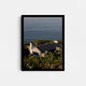 A framed fine art photography print featuring a gray shingled house overlooking blue ocean.